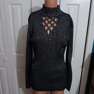 A BLACK AND SILVER DRESSEY SWEATER MADE BY REBA L